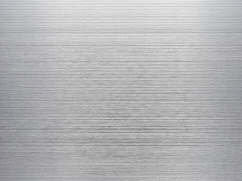 Close up view of brushed metal surface with horizontal textures with emphasizing smooth horizontal showcases highly detailed clean