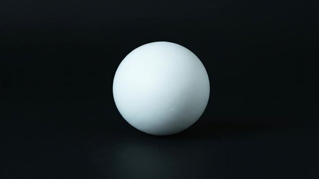 White egg isolated on black background.