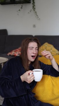 Vertical screen Young woman depends on coffee to overcome morning exhaustion showing how poor sleep and constant fatigue can turn caffeine into a daily necessity