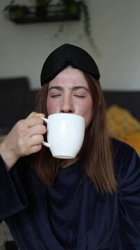 Vertical screen Coffee instantly changes her mood as woman goes from self doubt to confidence smiling at her reflection after the first energizing sip of caffeine