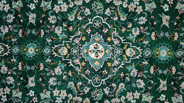 Traditional Green Carpet with Intricate Floral and Geometric Medallion Design