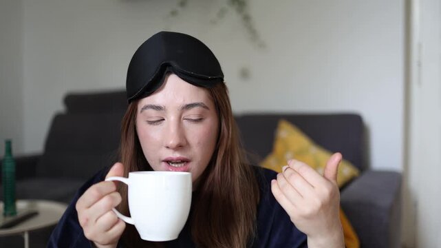 Woman smiles at her first cup of coffee after waking up knowing caffeine is the only way to overcome morning fatigue and finally feel awake and energized