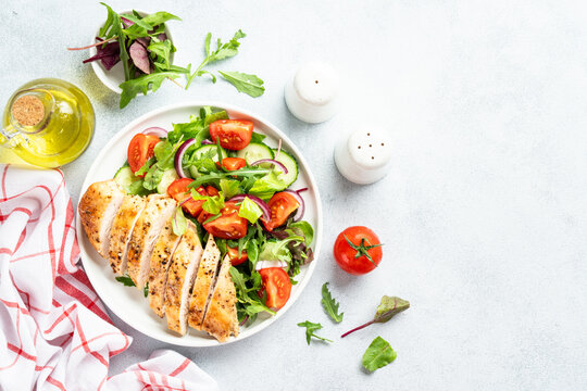 Green salad with leaves, tomatoes, cucumber.