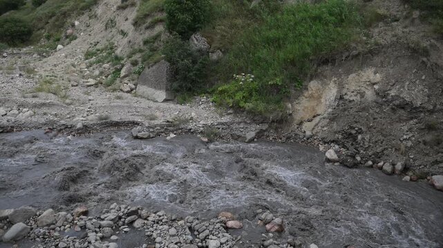 Background of a mountain river with strong flow, cloudy after precipitation