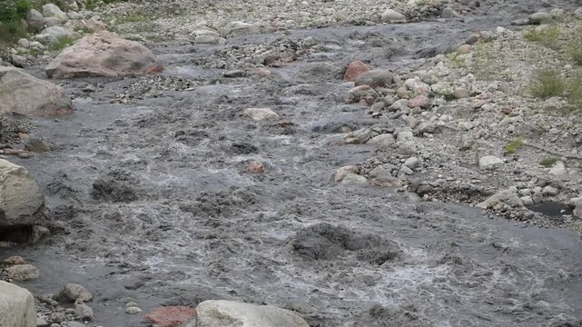 Background of a mountain river with strong flow, cloudy after precipitation