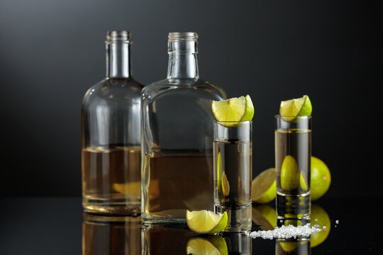 Gold tequila with sea salt and lime slices.