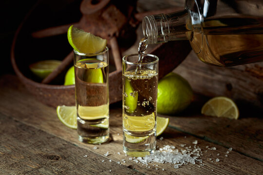 Tequila with salt and lime slices.