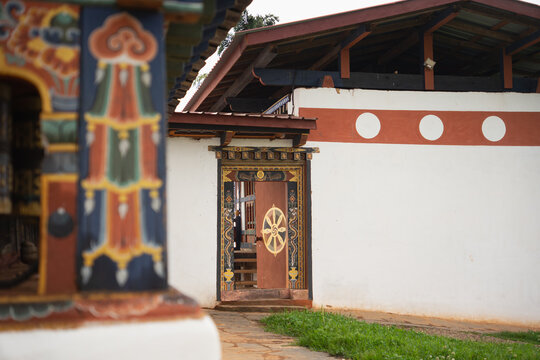 Traditional Bhutanese door with dharmachakra at temple