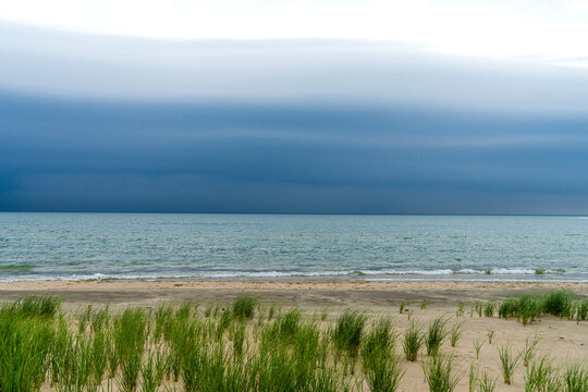 Shelf cloud storm system over Lake Michigan with dune grass near Holland, Michigan