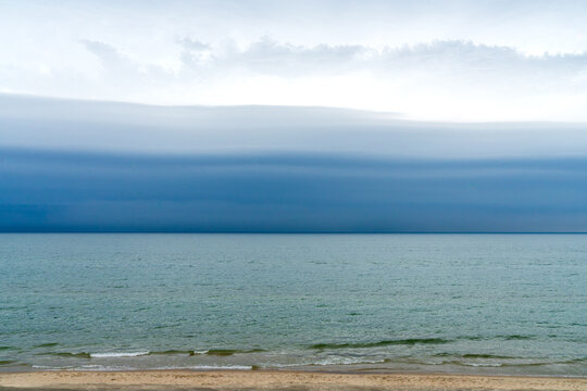 Shelf cloud storm rolling over Lake Michigan shoreline near Holland, Michigan