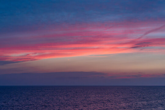 Vivid pink and purple sunset sky over Lake Michigan near Holland Michigan
