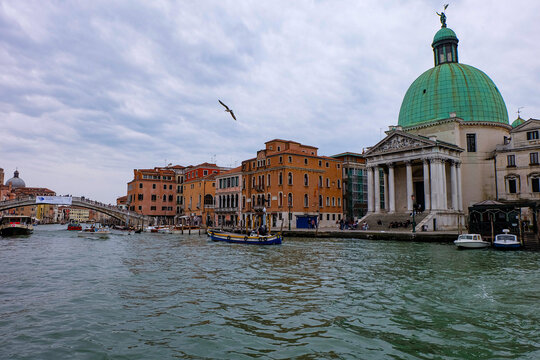 Ambiance and atmosphere in Venice with canals, boats, water taxi, gondola and colorful buildings 