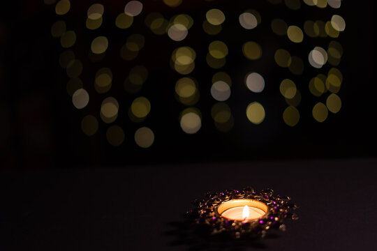 Candle with soft golden bokeh, festive spiritual background