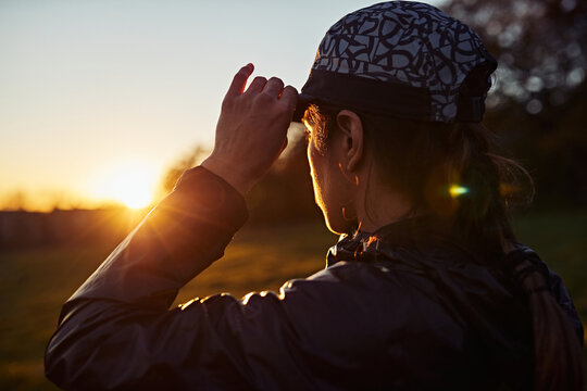 Backlit Runner Preparing For Exercise In Open Countryside