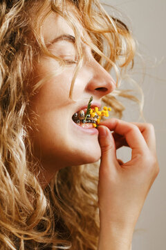 A woman cleaning her braces