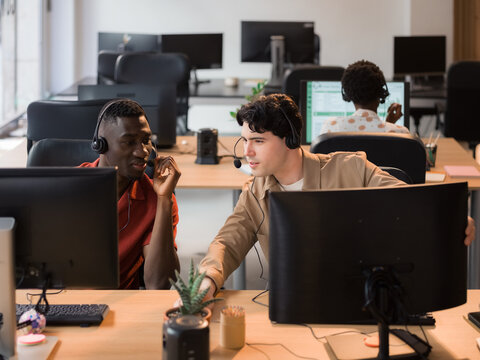 Two People Working Together in a Busy Office During Daytime