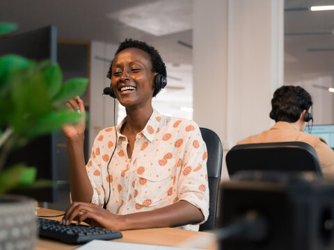 Cheerful customer service specialist working with client at office