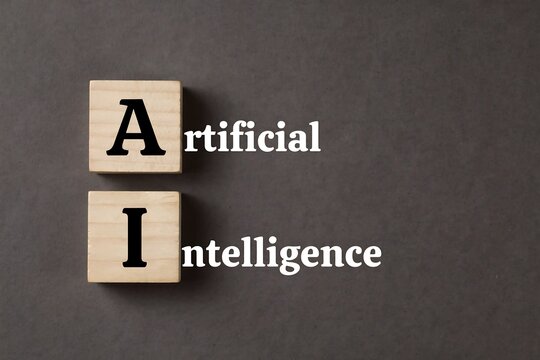 Artificial intelligence text on wooden blocks. AI concept for modern digital technology.