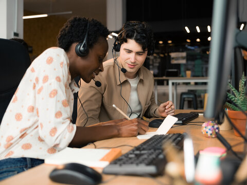 Friendly worker helping to newbie at office 