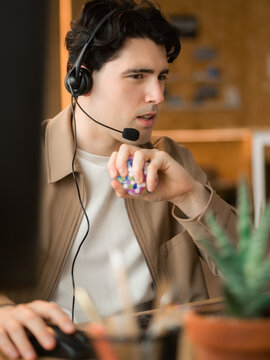 Man listening to client via headset at office 