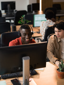 Employees Work at Desks in a Busy Office During the Day