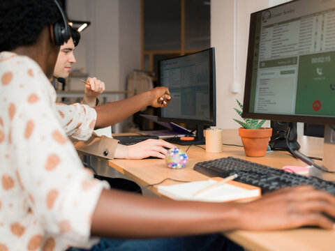 Woman helping to her colleague at office 