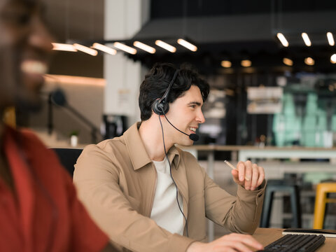 Call Center Agents Work Together During the Day in a Busy Office