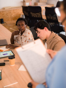 Woman asking questions during meeting 