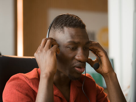 Man Wearing Headset Speaks During a Call in an Office Setting