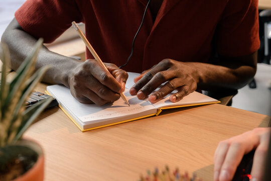 Man taking notes at work 