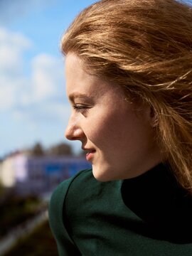 Woman Looking Away From the Camera on a Sunny Day Outdoors