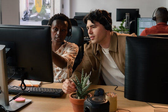 Experienced worker helps to younger colleague information 