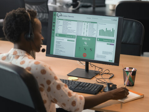 Call Center Worker Using Computer to Manage Tasks During Office Hours