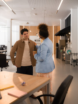 Employee is listening to his boss after meeting at office 