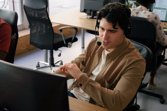 Positive call center worker is talking to client in office