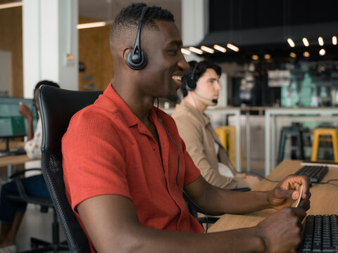 Positive call center workers at office 