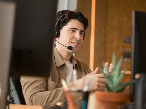 Smiling man providing customer support at office 