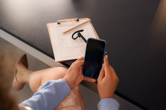 Woman using smartphone at office 