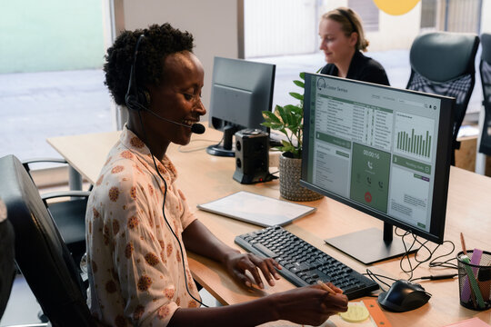 Woman talking to client at call center 