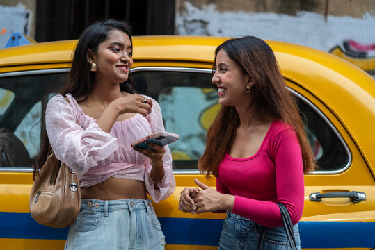 Two young Indian woman interacting at outdoors in daytime