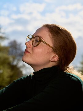 Woman Enjoying the Outdoors While Wearing Glasses in Natural Light
