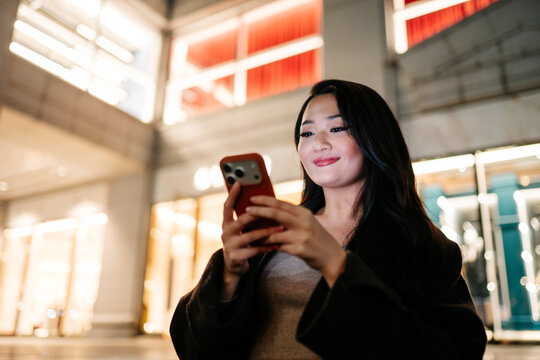 Japanese using smartphone in Tokyo at night