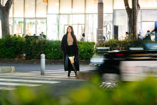 Japanese crossing Tokyo street at night