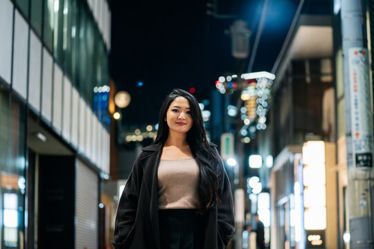 Woman posing confidently in Tokyo night city