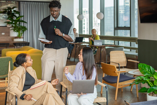 Team Members Discuss Ideas in Modern Office Space Downtown