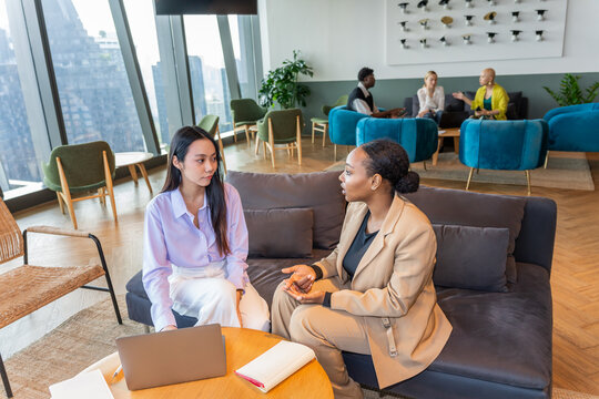 Two Women Have a Meeting in a Modern Office Space