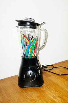 Conceptual image of blender filled with art drawing colour pencils