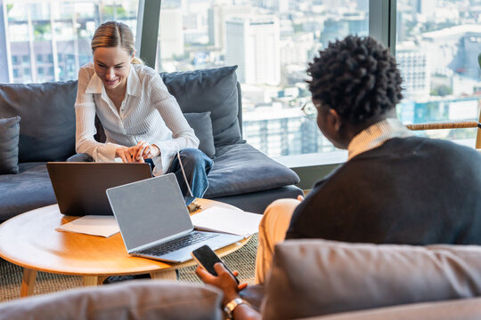 Meeting in a City Office With Laptops and Conversation Happening