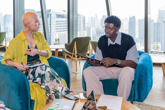 Two People Discuss Ideas in a Modern Workspace in the City