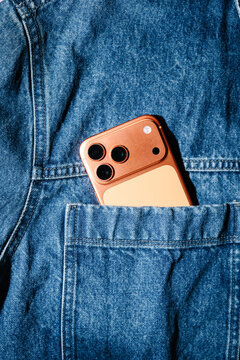 Copper Colored Smartphone In Denim Jacket Pocket